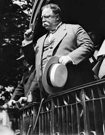 Schwarzweiss-Foto des zukünftigen Präsidenten William Howard Taft, der eine Wahlkampfrede von einem Bahnsteig hält.