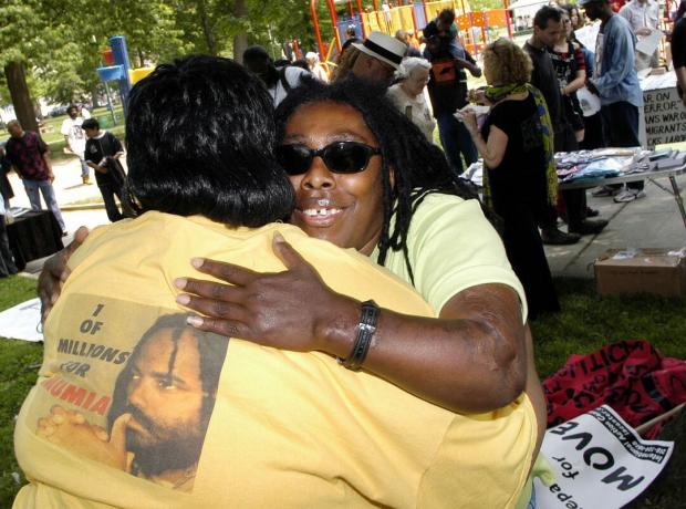 Ramona Africa (R), die einzige Überlebende der MOVE-Tragödie von 1985, umarmt Denise Garner (L) während eines Gedenkmarsches im Jahr 2005